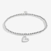 Joma Jewellery Merry Christmas silver beaded bracelet with open‑heart charm, cut‑out on white background.
