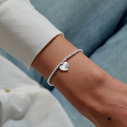 “Merry Christmas Wonderful Mum” heart bracelet worn on wrist – perfect Christmas present from daughter or son.
