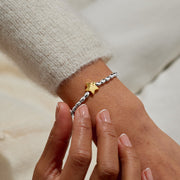 Joma Merry Christmas bracelet worn on wrist