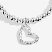 Close-up of Joma Merry Christmas Super Sister bracelet heart charm