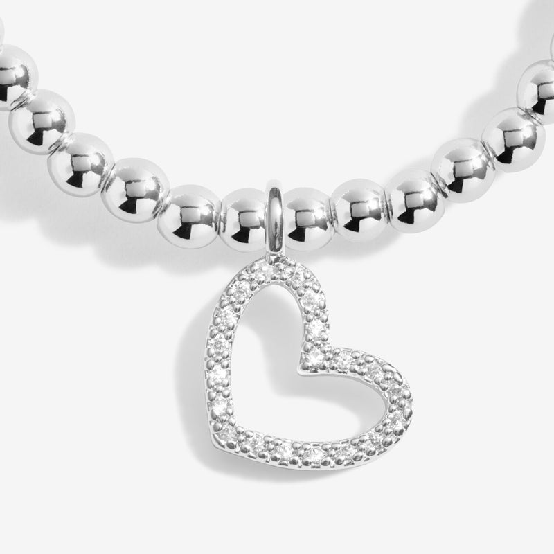 Close-up of Joma Merry Christmas Super Sister bracelet heart charm