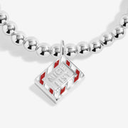 Close-up of Joma Nice List bracelet charm