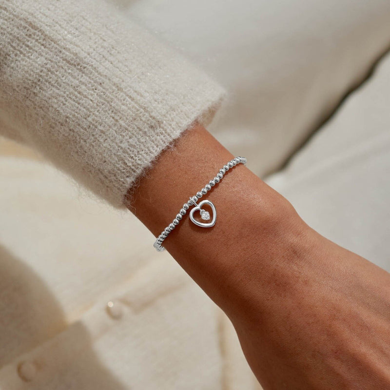“One in a Million” open‑heart bracelet styled on wrist – sparkling jewellery for Christmas or everyday.

