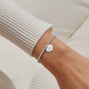 Joma Jewellery paw‑print heart charm bracelet styled on wrist – elegant silver bracelets, ideal gifts for women and dog mums.


