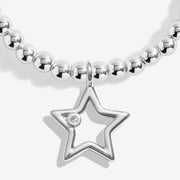Close‑up of polished outline star charm with single crystal on Joma Jewellery Secret Santa festive bracelet.
