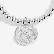 Close-up of Joma sun moon stars bracelet engraved disc charm