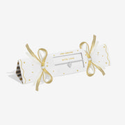 White and gold cracker‑style gift box presenting Joma Jewellery With Love layered‑heart bracelet.

