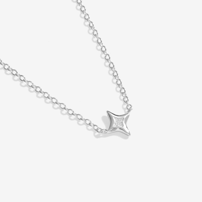 Close‑up of polished heart pendant featuring sparkling pavé centre on delicate adjustable silver chain.
