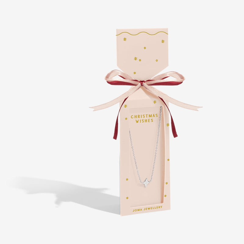 White cracker‑style gift box with gold bow presenting Joma Jewellery With Love silver heart necklace.
