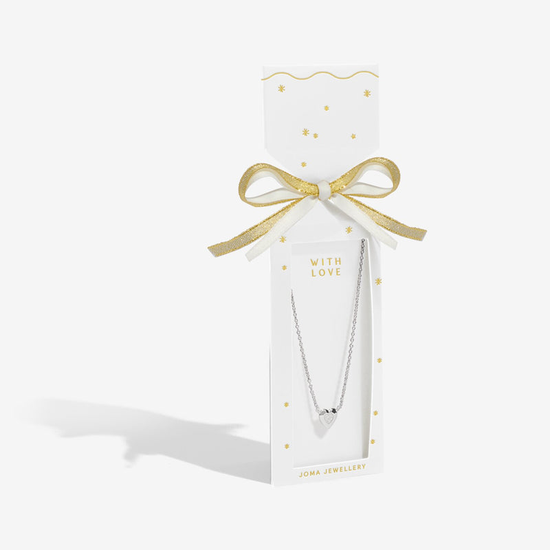 White cracker‑style gift box with gold bow presenting Joma Jewellery With Love silver heart necklace.