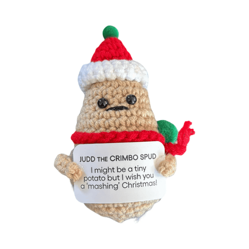 Crochet Christmas potato decoration Judd the Chrimbo Spud wearing a Santa hat and scarf, holding a festive message card on white background
