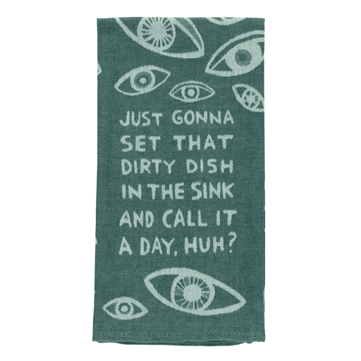 Close-up of teal woven cotton tea towel with eye print and dirty dish in the sink slogan.
