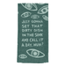Close-up of teal woven cotton tea towel with eye print and dirty dish in the sink slogan.
