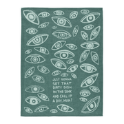 Full view of teal woven cotton tea towel with all-over eye pattern and dirty dish slogan.