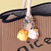 Kawaii Bread Cat Keychain Mystery Blind Box charms clipped onto a knitted tote bag