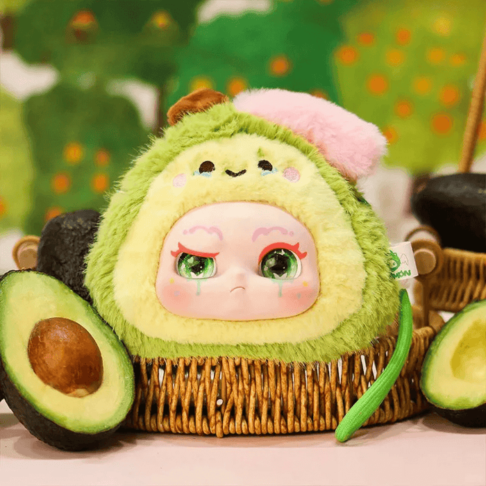 Avocado plush blind box character – green fruit with pit‑hat and pouty face.
