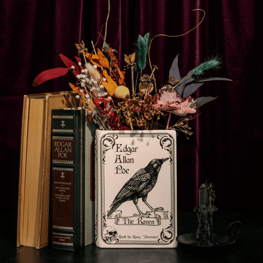 The Raven book vase displayed with dried flowers in a gothic home decor setting
