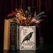 The Raven book vase displayed with dried flowers in a gothic home decor setting
