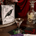 Large The Raven ceramic book vase styled on a shelf with books and dried flowers