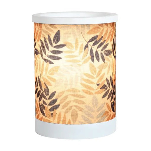 Leaves design electric wax melt burner switched on, glowing warmly through the leafy pattern.