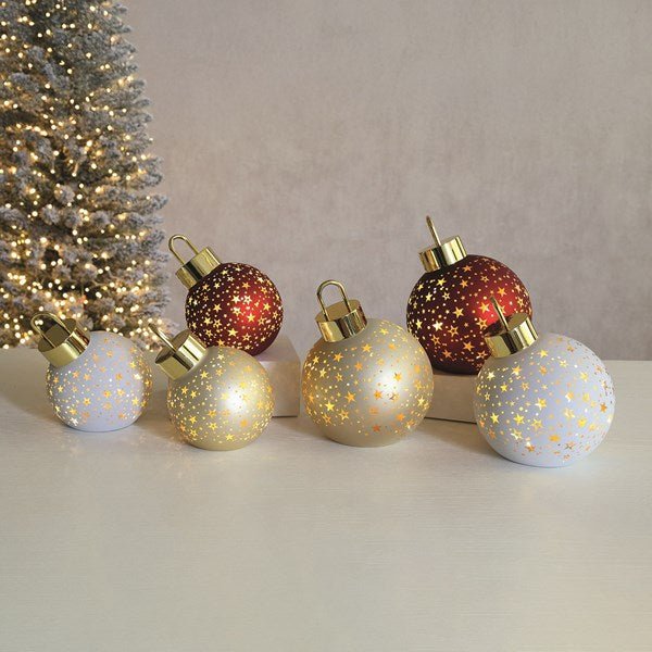 Group of LED bauble decorations glowing on tabletop, including red 12cm bauble.

