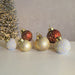Group of LED bauble decorations glowing on tabletop, including red 12cm bauble.


