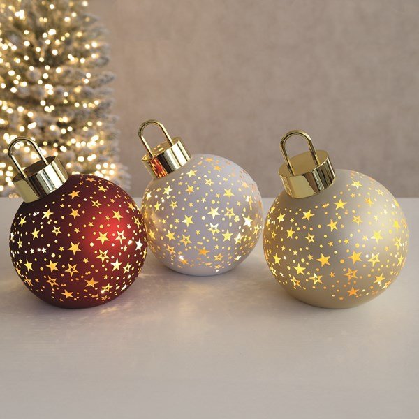 Trio of LED bauble decorations glowing with gold star cut-outs in red, white and champagne.