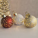 Trio of LED bauble decorations glowing with gold star cut-outs in red, white and champagne.