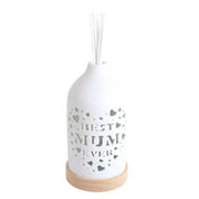 White ceramic Best Mum reed diffuser assembled on a wooden base with reed sticks in place.