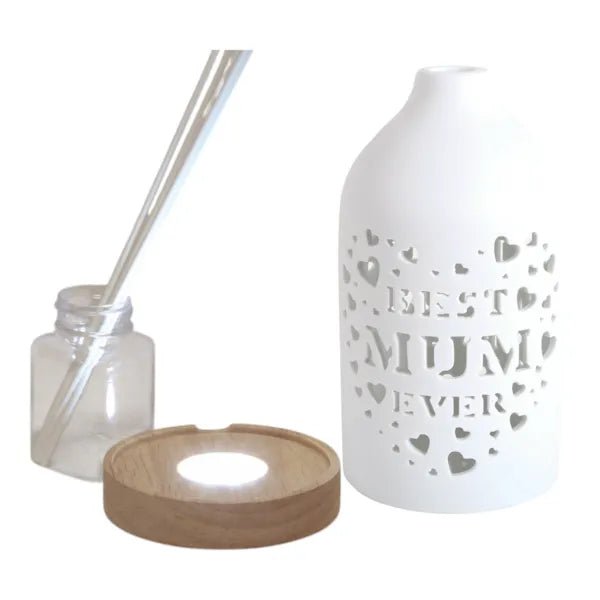 Reed diffuser set components showing the ceramic Best Mum cover, wooden LED base, bottle and reed sticks.