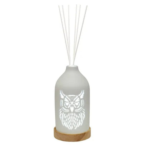 White LED ceramic owl reed diffuser on a wooden base with white reed sticks and an owl cut-out design.