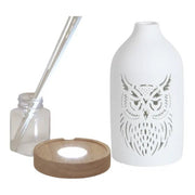 Reed diffuser set components showing the ceramic owl cover, wooden LED base, bottle and reed sticks.