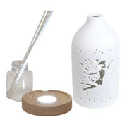 Disassembled fairy diffuser with ceramic cover, LED base, reed sticks, and bottle

