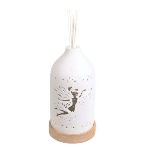 Unlit fairy-themed ceramic reed diffuser with white finish and wooden base

