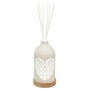 LED ceramic reed diffuser with glowing heart cut-out and white reed sticks


