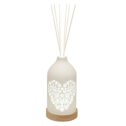 LED ceramic reed diffuser with glowing heart cut-out and white reed sticks

