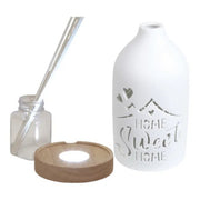 Disassembled LED reed diffuser showing base, glass bottle, reeds, and ceramic cover

