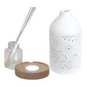 Disassembled reed diffuser with ceramic cover, bottle, LED wood-effect base, and sticks