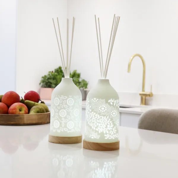 LED ceramic leaf diffusers glowing on kitchen island with fruit bowl and tap in background