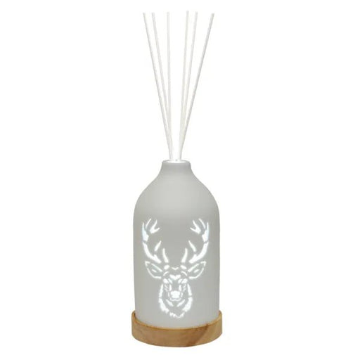 White LED ceramic stag reed diffuser on a wooden base with white reed sticks and a stag head cut-out design.