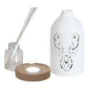 Reed diffuser set components showing the ceramic stag cover, wooden LED base, bottle and reed sticks.