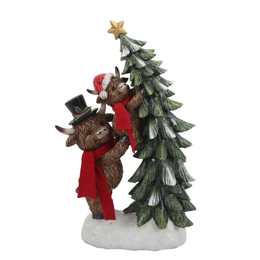 32cm LED ornament of two Highland cows in red scarves holding a snowy Christmas tree with star.

