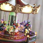 Close-up of carousel animals and lit canopy

