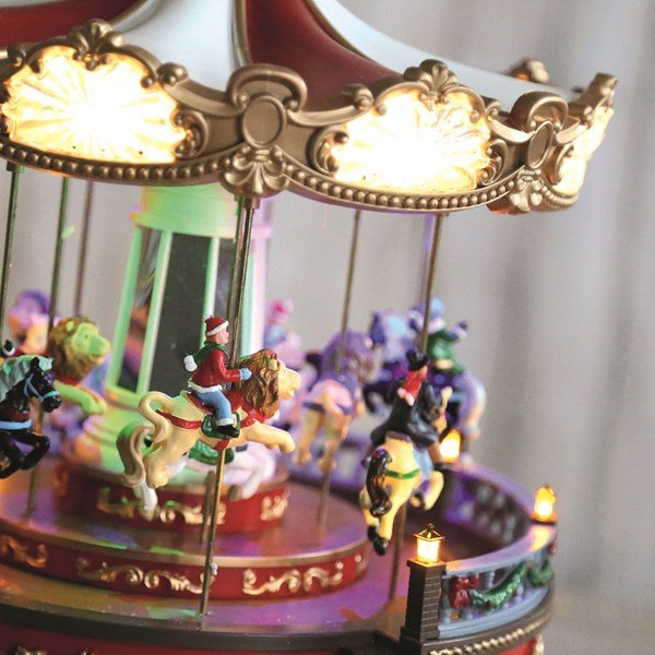 Close-up of carousel animals and lit canopy

