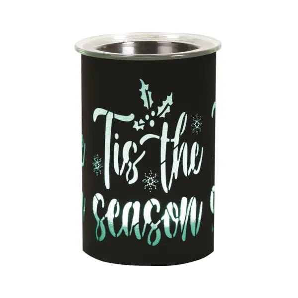 Black LED wax melter glowing green through Tis the Season cut-out