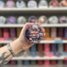 Lemon Lavender wax melt pot held in hand with colourful wax melt display in the background