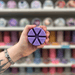 Lemon Lavender wax melt segments held in hand with colourful wax melt display in the background