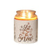 White Let It Snow sleeve used as a candle jar holder with lit jar inside