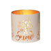 Round white and gold Let It Snow tealight candle holder shown glowing