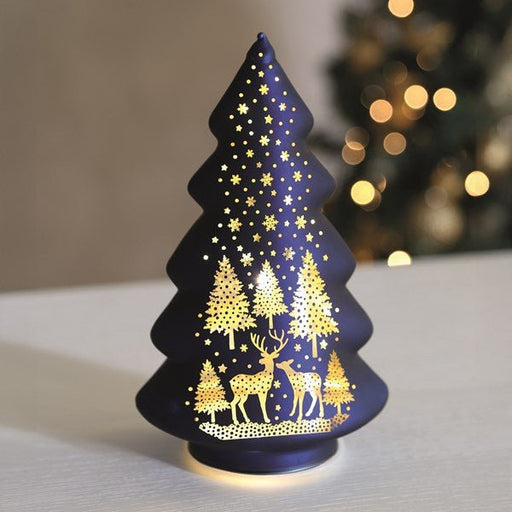 Light-up blue glass tree glowing with warm LEDs on a table

